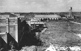 The Assembly Hall in the foreground. On the left Huts A, B and C lie between it and the Dining Hall. The tower in the background supplied salt water for washing.