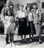 My mother's eldest brother, Ezra and his family. In front is the youngest daughter, Elsie, at back from left to right are my uncle Ezra, his wife Girgee, daughters Jenny and Rosie. (1956)